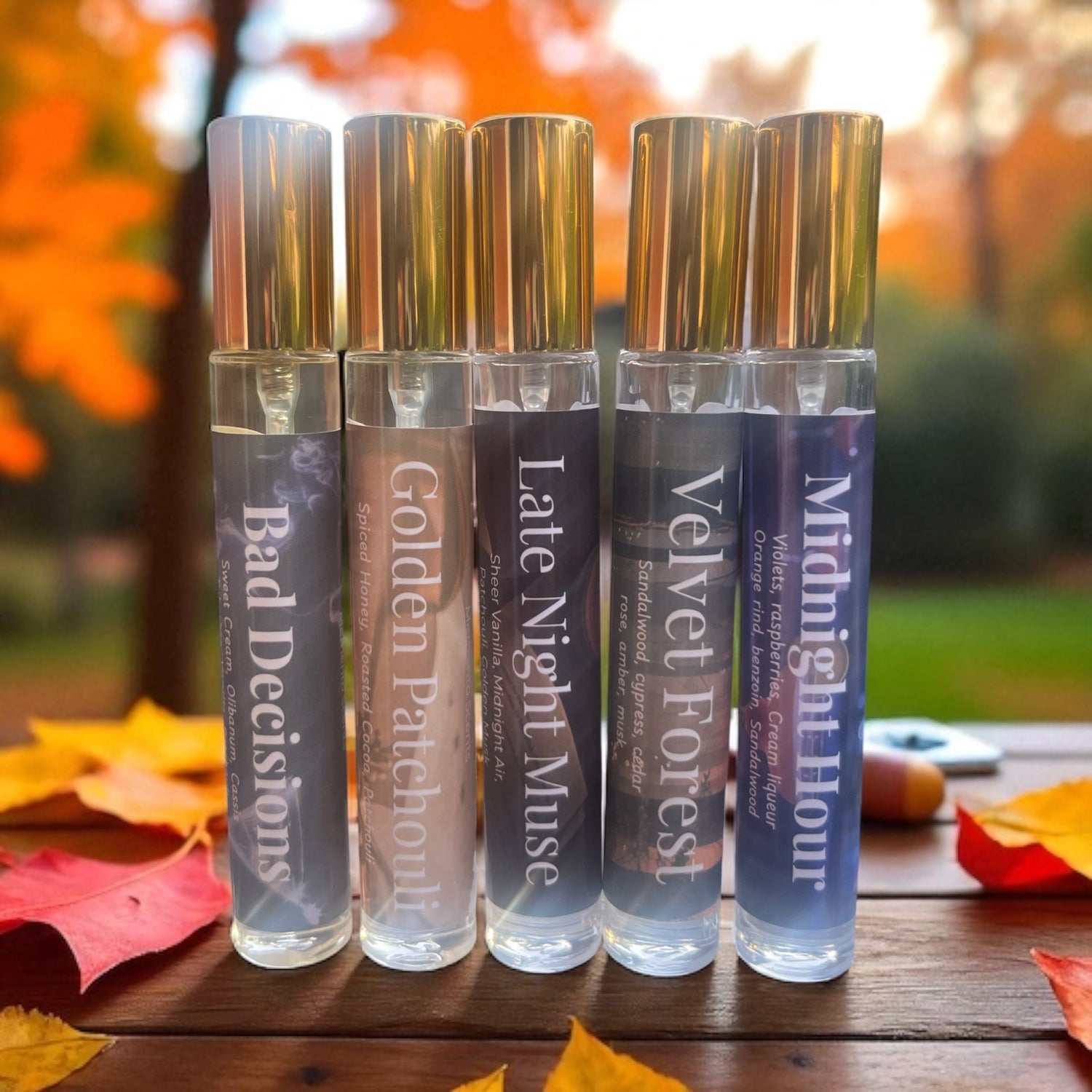 Fall perfume bottle collection on a wood table in the fall
