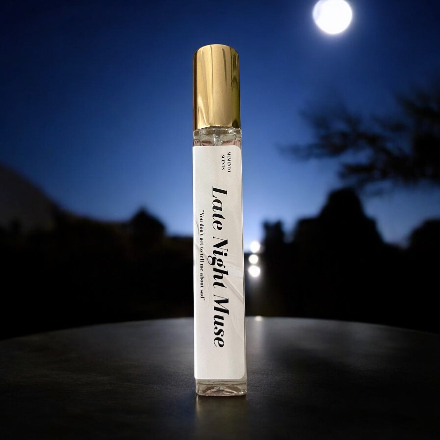 Late Night Muse perfume bottle, surrounded by the mysterious allure of midnight air, night-blooming jasmine, vanilla, and earthy notes, with golden accents