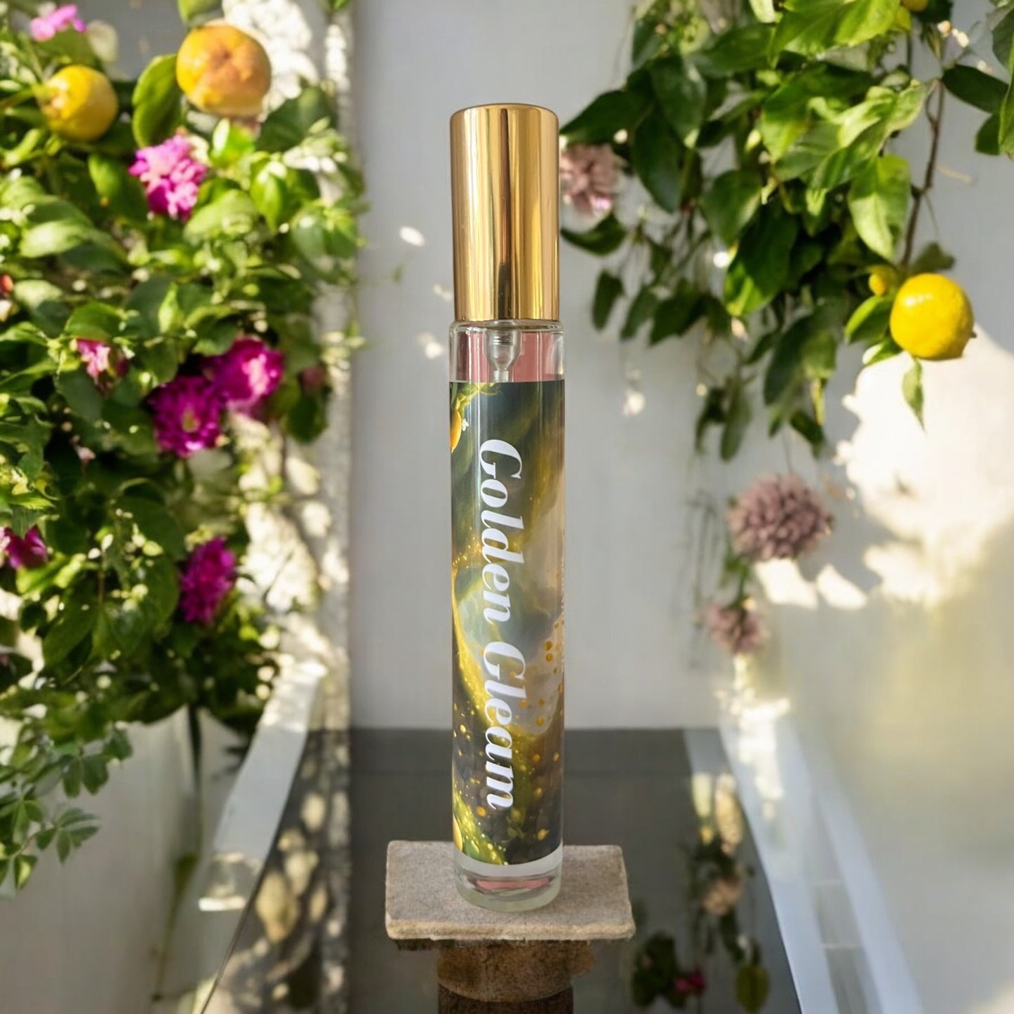 Golden Gleam perfume bottle surrounded by lemons and florals