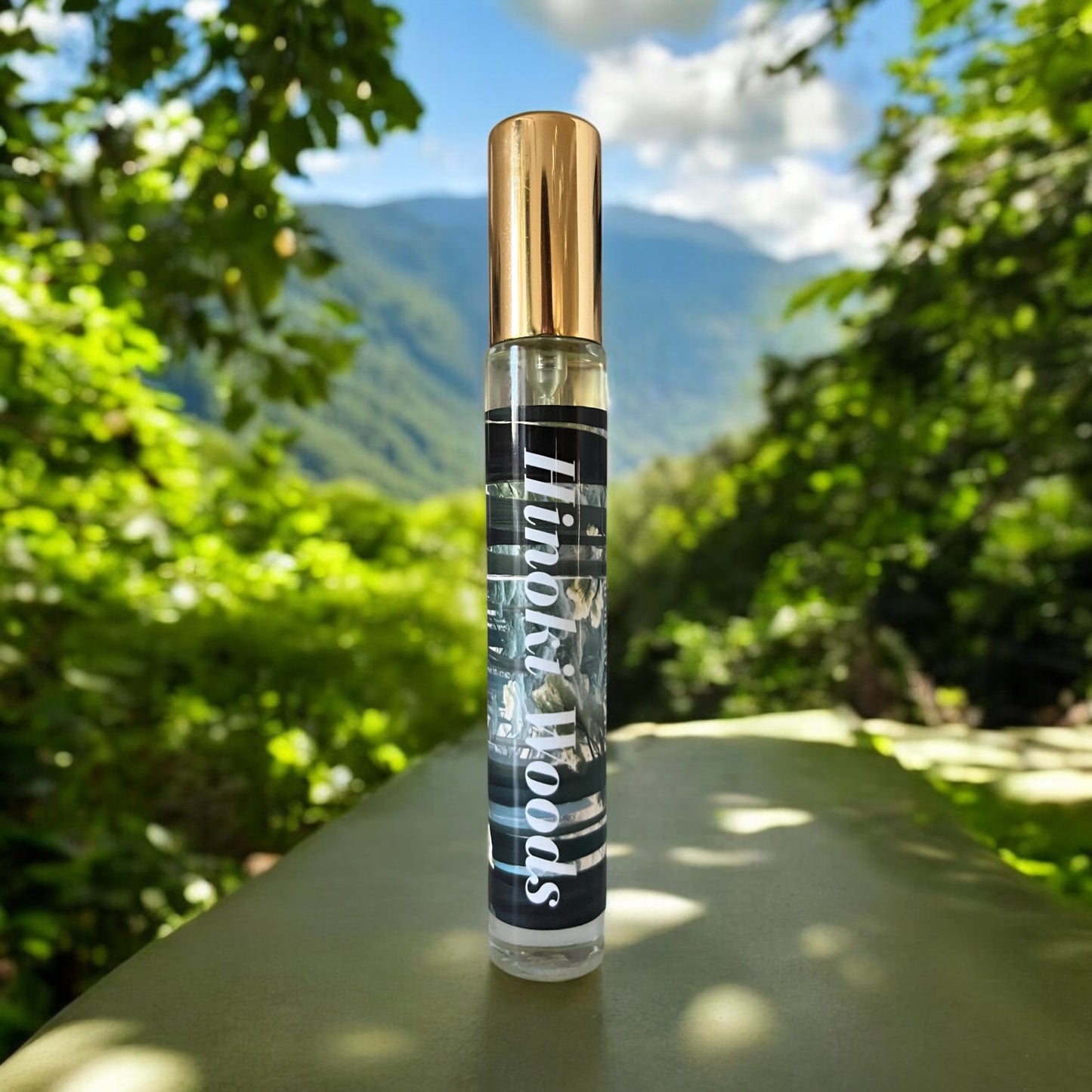 Hinoki Woods perfume bottle, surrounded by tranquil forest elements and the natural beauty of Kiso Valley, with notes of orange, bergamot, grapefruit, vetiver, eucalyptus, neroli, amber, hinoki cypress, and musk.