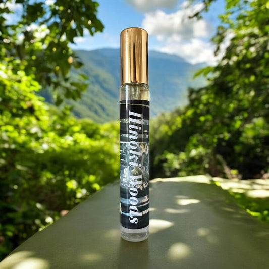 Hinoki Woods perfume bottle, surrounded by tranquil forest elements and the natural beauty of Kiso Valley, with notes of orange, bergamot, grapefruit, vetiver, eucalyptus, neroli, amber, hinoki cypress, and musk.