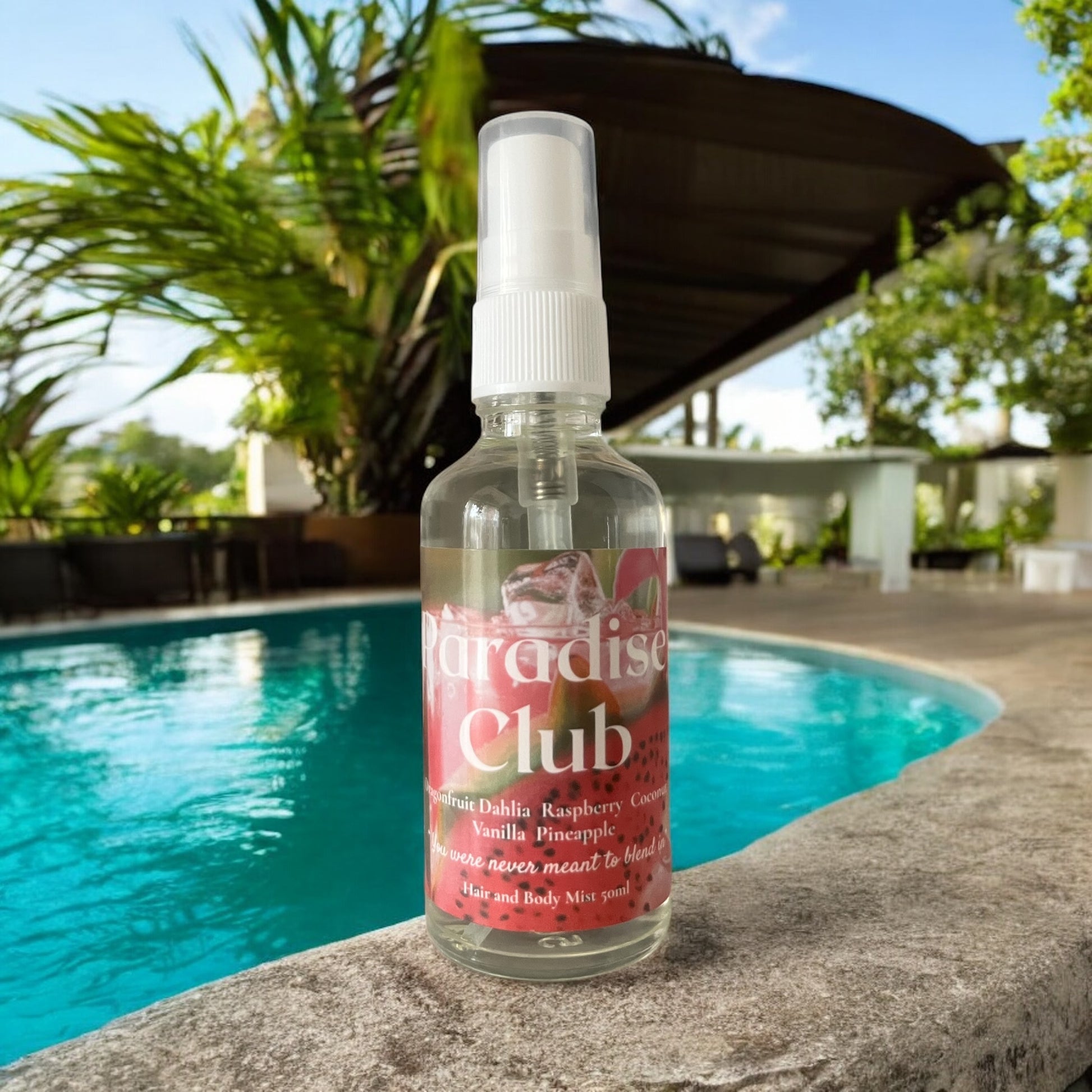 Paradise Club Hair and Body mist bottle poolside evoking a tropical lush vibe
