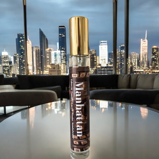 Manhattan perfume bottle, surrounded by the warm ambiance of a cigar lounge, with notes of tobacco leaf, vanilla pods, cacao, dried fruits, cedarwood, and sandalwood.