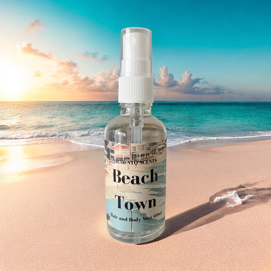 Beach Town perfume with notes of sea breeze, bergamot mint, jasmine, sea salt, coastal sage, and driftwood, evoking the fresh, calming essence of a coastal getaway.