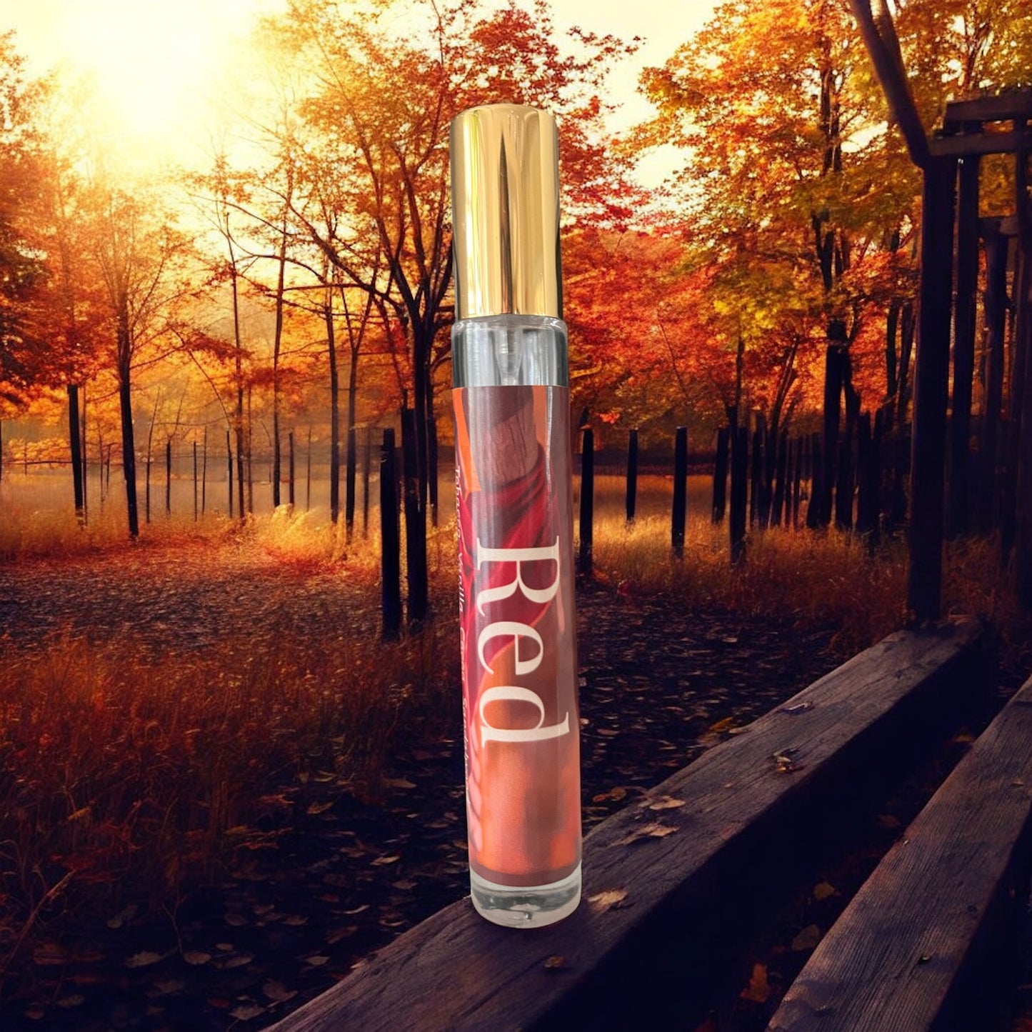 Red perfume bottle on a wooden platform with autumn trees in the background