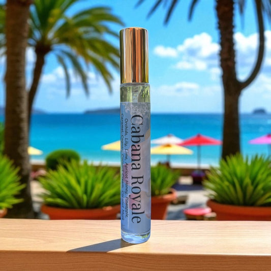 Bottle of Perfume labeled 'Cabana Royale' on a table with a beach and palm trees in the background