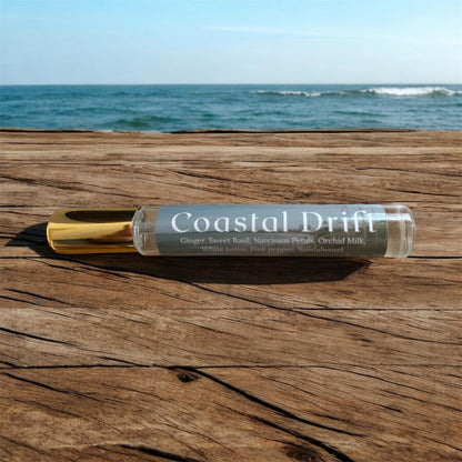 Spray bottle labeled 'Coastal Drift' on a wooden surface with ocean in the background