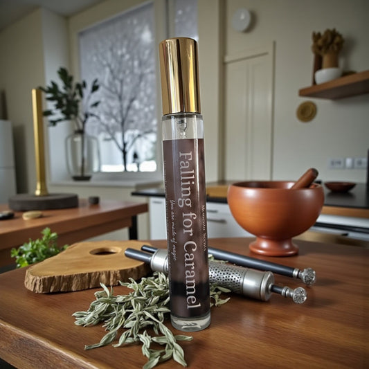 Perfume bottle labeled 'Falling for Caramel' on a wooden surface with kitchen items in the background