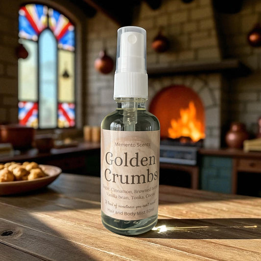 Bottle of 'Golden Crumbs'Hair and body mist  on a wooden table with a fireplace and stained glass window in the background