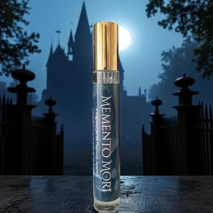 Perfume bottle labeled 'Memento Mori' with a castle silhouette in the background
