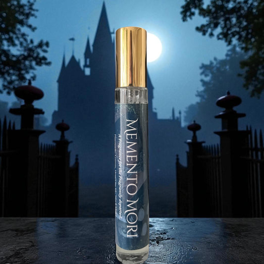 Perfume bottle labeled 'Memento Mori' with a castle silhouette in the background