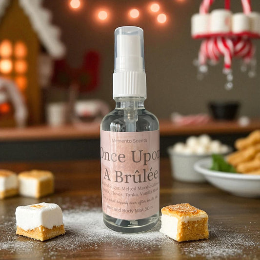 Hair and body mist bottle  'Once Upon A Brulée' on a wooden surface with dessert items and festive background.