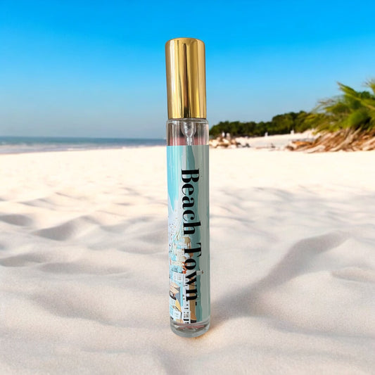Beach Town perfume with notes of sea breeze, bergamot mint, jasmine, sea salt, coastal sage, and driftwood, evoking the fresh, calming essence of a coastal getaway.