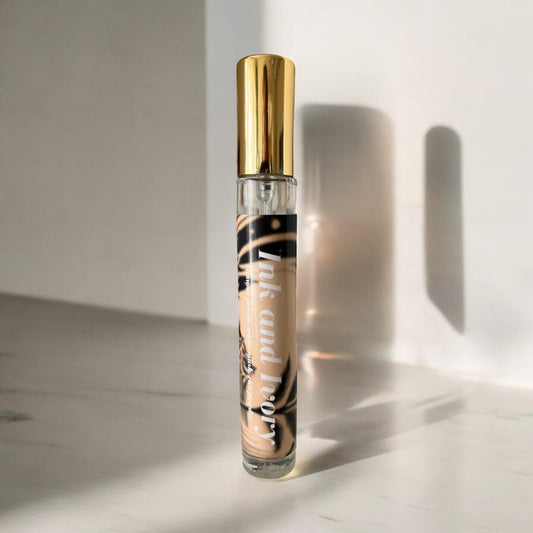 Ink & Ivory perfume bottle, set against a clean background , with notes of mimosa petals, white musk, sesame seeds, and rice powder.

