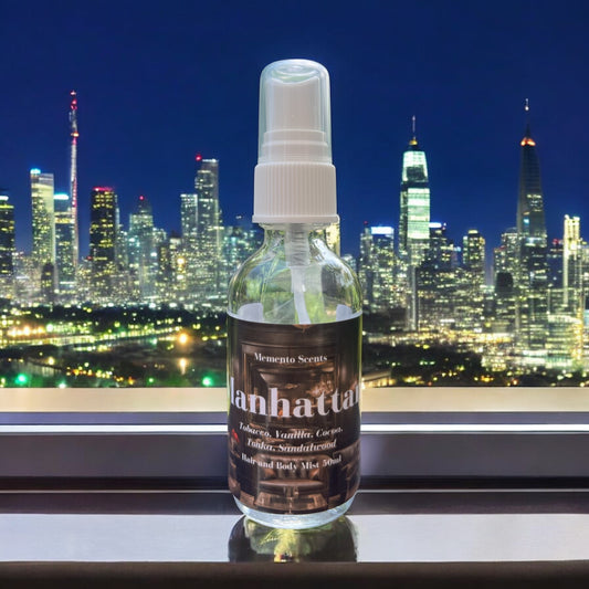 A bottle of Manhattan Hair and body mist on a windowsill overlooking Manhattan at night  with notes of vanilla, tobacco and cocoa