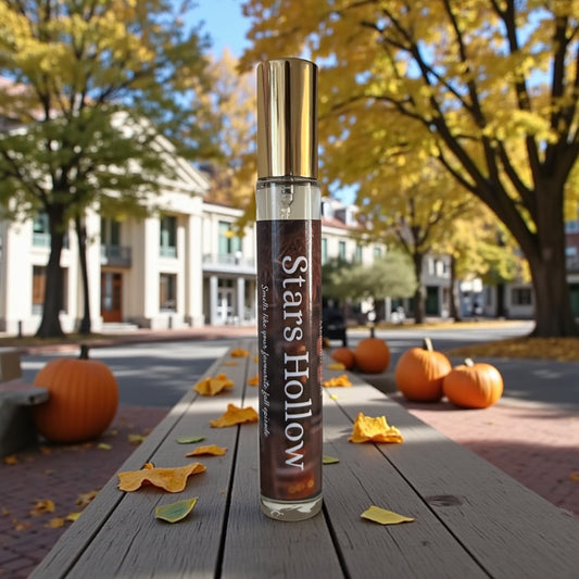 A perfume bottle labelled Stars Hollow on a bench on Main street in the fall 
