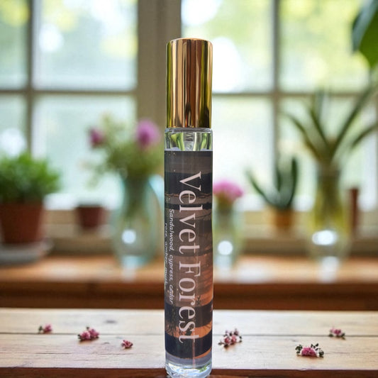 Perfume bottle labeled 'Velvet Forest' on a wooden surface with a blurred indoor background